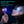 Handheld double sided red and blue light therapy device held near a person face