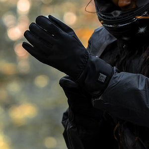 Person wearing black Venture Heat heated gloves with power button on the wrist
