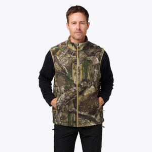 Man wearing a Mobile Warming camouflage print heated vest over a black long sleeve shirt