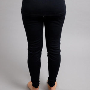 Back view of Merino Skins black thermal leggings on a person