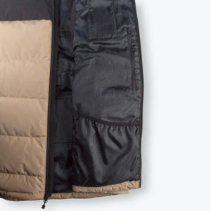 Interior view of Mobile Warming jacket showing black lining with topographic pattern and zippered pocket
