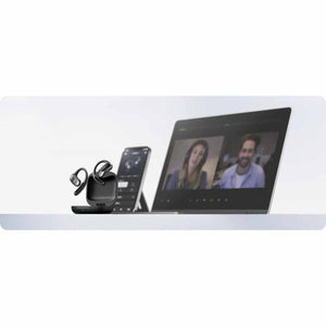 Shokz open ear earbuds in charging case next to a smartphone and laptop displaying a video call