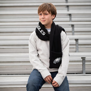 Boy wearing a black Philadelphia Eagles fleece scarf with team logo and text