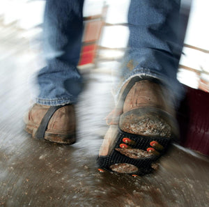 Person wearing ice cleats on boots walking on icy surface