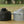 Snow Peak Giga Power battery and a Snow Peak gas canister on a wooden surface