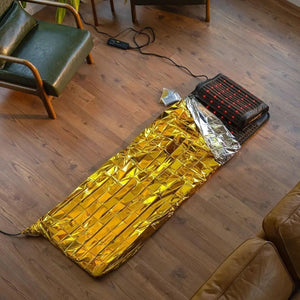 HealthyLine infrared therapy mat with gold reflective cover on wooden floor