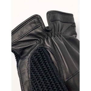 Close up of black Hestra leather glove cuff with knitted detail
