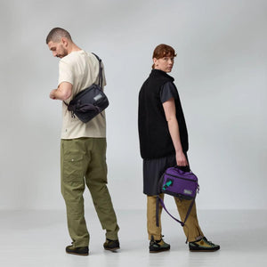 Two people wearing Fjallraven crossbody bags against a grey background