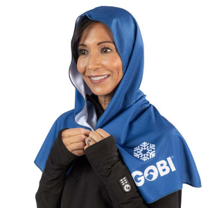 Woman wearing a blue Gobi Heat cooling hood over a black shirt
