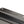 Close up of a black Snow Peak metal component with embossed logo and mounting holes