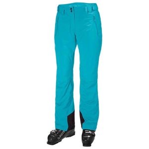 Helly Hansen turquoise ski pants with black boot gaiters and black ski boots