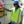 Worker wearing a HyperKewl high visibility cooling vest and blue hard hat next to a water cooler