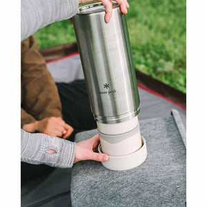 Snow Peak stainless steel tumbler being assembled with a white base