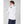 Man wearing a white Helly Hansen hooded jacket with HH branding