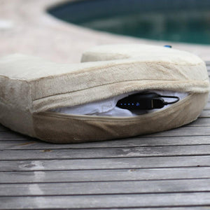 Volt Heat beige travel pillow with battery pack inserted in zippered side pocket