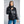 Woman wearing a black 8K FlexWarm puffer jacket with a high collar