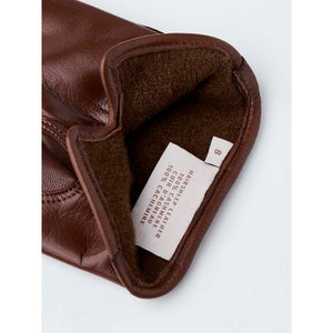 Interior of brown Hestra leather glove showing size 8 label and material composition