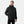 Man wearing a black Helly Hansen hooded rain jacket