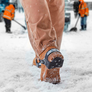 Devisys heel ice grip attached to a work boot in snowy conditions