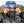 Person wearing a California Heat jacket and HJC helmet adjusting a black face mask