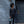 Person standing by a door holding a Thule travel bag