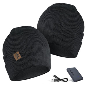 Two black ActionHeat knit beanies with a power bank and USB charging cable