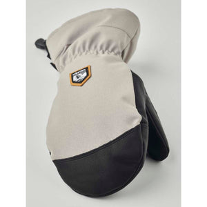 Hestra beige and black leather mitten with brand logo patch