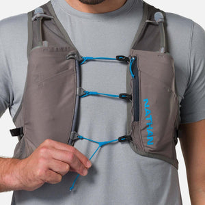 Person wearing a grey Nathan hydration vest with blue bungee cord adjustments