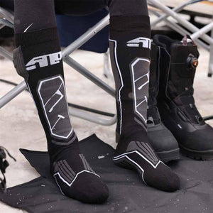 Person wearing black knee high technical socks with white graphic patterns