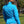 Back view of a woman wearing a blue Volt Heat fleece jacket with grey seam detailing