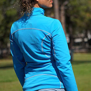 Back view of a woman wearing a blue Volt Heat fleece jacket with grey seam detailing