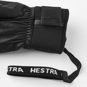 Black leather Hestra glove cuff with adjustable velcro strap and branded wrist tether