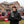Man wearing Arizona Cardinals branded winter gear holding a steaming mug at a tailgate party