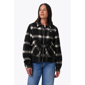 Woman wearing a Mobile Warming black and white plaid zip up jacket with front pockets