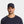 Man wearing a navy Mission baseball cap