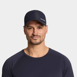 Man wearing a navy Mission baseball cap