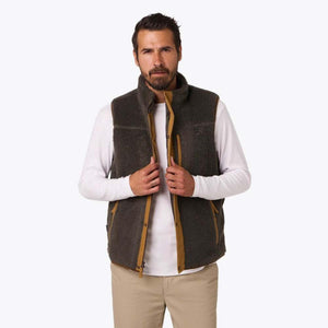 Man wearing a dark grey Mobile Warming fleece vest over a white long sleeve shirt