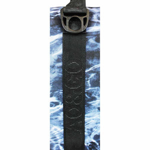Black nylon strap with embossed logo and plastic D-ring on blue and white patterned fabric