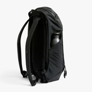 Bellroy black backpack side view with a water bottle in the side pocket