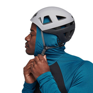 Person wearing a Black Diamond climbing helmet over a blue hooded base layer