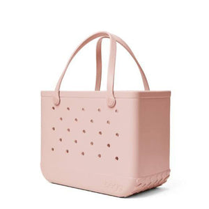 Light pink Bogg Bag tote with perforated side panels and dual handles
