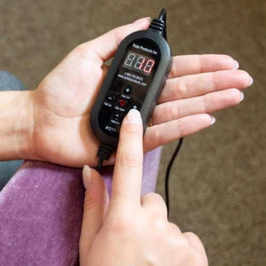 Hand holding a black Polar Products digital controller with buttons and a display screen