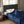 Person sleeping under a navy blue Woolrich heated blanket on a bed