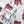 Fabric pattern featuring red houses, deer, and pine trees on a white background