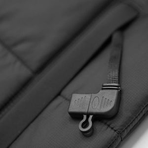 Black plastic zipper pull on a textured fabric garment