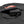 Black power bank with USB port and charging cable inside a zippered fabric pocket