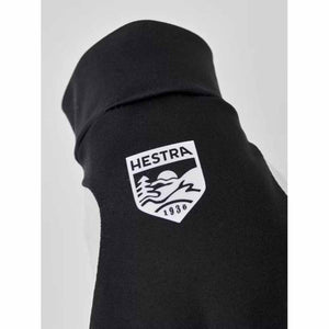 Black Hestra glove cuff with white brand logo patch