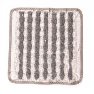 Square fabric pad with seven vertical channels containing dark grey stone beads
