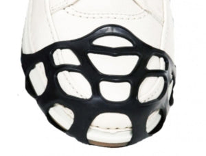 Due North black rubber ice traction cleat on the toe of a white shoe