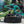 Open Thule duffel bag filled with cycling gear on a gravel path near a mountain bike